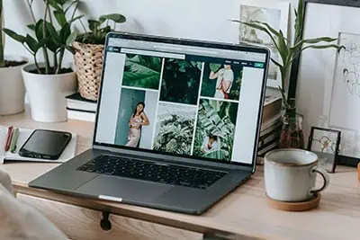 Image of a desk with a laptop on it showing a collage of images