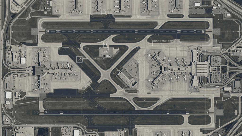 High-resolution nadir satellite view of a commercial airport runway and taxiways, featuring subtle AI overlays including digital bounding boxes and 'object detected' labels around simplified aircraft shapes.